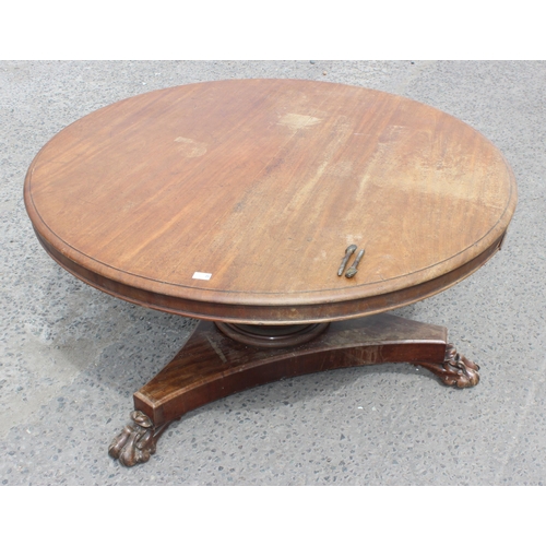 28 - A 19th century mahogany tilt topped breakfast table with impressive carved pedestal base with lion p... 