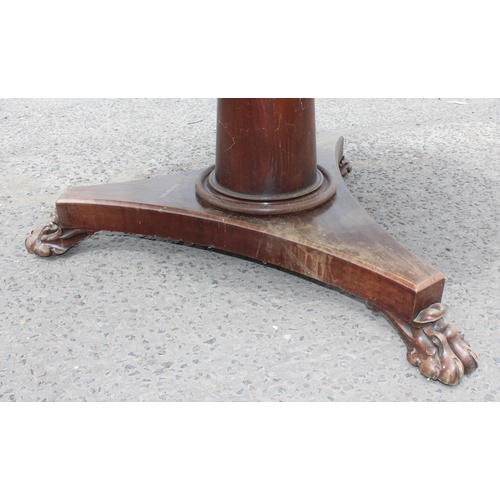 28 - A 19th century mahogany tilt topped breakfast table with impressive carved pedestal base with lion p... 