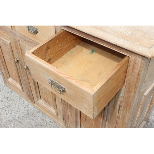 1 - A 19th century pitch pine sideboard with 3 drawers over 3 cupboards, approx 137cm wide x 92cm tall x... 