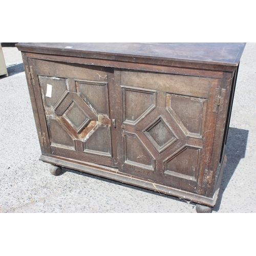 14 - An 18th century 2 door oak cupboard standing on ball feet, approx 130cm wide x 102cm tall x 55cm dee... 