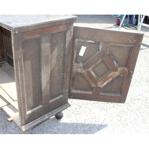 14 - An 18th century 2 door oak cupboard standing on ball feet, approx 130cm wide x 102cm tall x 55cm dee... 