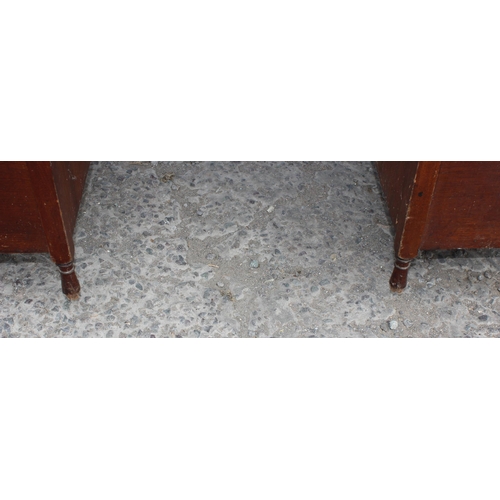 7 - An early 20th century leather topped desk with a long central drawer and 2 banks of 4 drawers with b... 