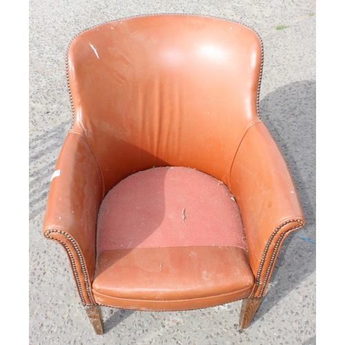 45 - A vintage brown studded leather or leatherette tub chair, lacking cushion