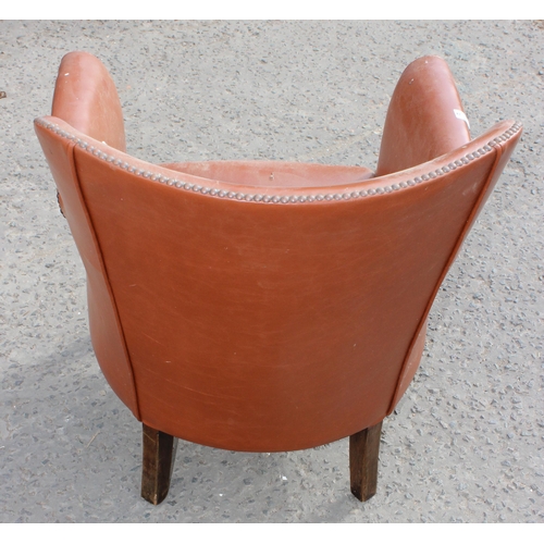 45 - A vintage brown studded leather or leatherette tub chair, lacking cushion