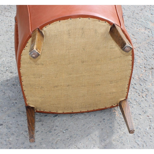 45 - A vintage brown studded leather or leatherette tub chair, lacking cushion