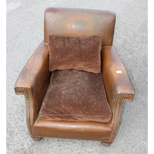 17 - A pair of Art Deco period brown leather or leatherette library chairs with studded decoration and ca... 