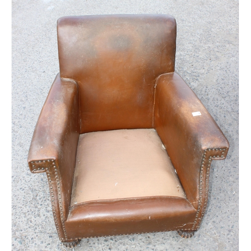 17 - A pair of Art Deco period brown leather or leatherette library chairs with studded decoration and ca... 