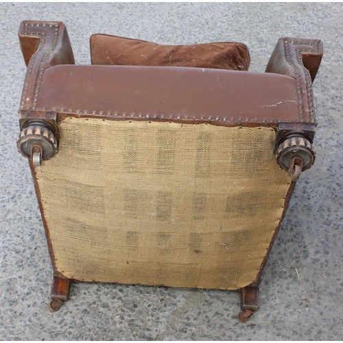 17 - A pair of Art Deco period brown leather or leatherette library chairs with studded decoration and ca... 