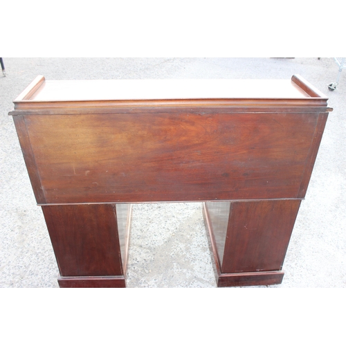 9 - A Victorian mahogany cylinder desk, the roll top concealing six drawers and five pigeon holes, the p... 