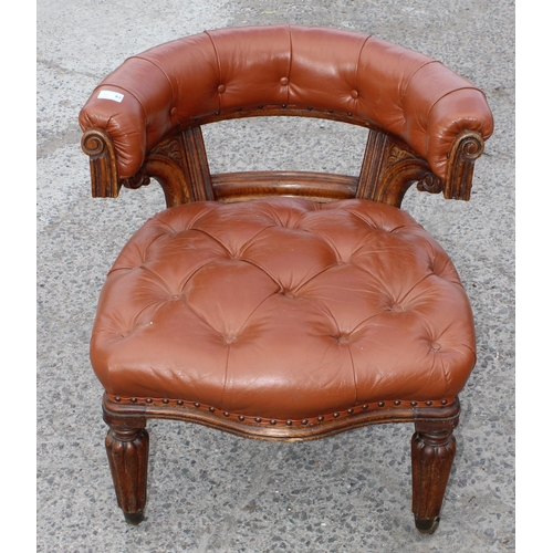 11 - An antique brown leather and oak library or desk chair with Chesterfield studded upholstery, likely ... 