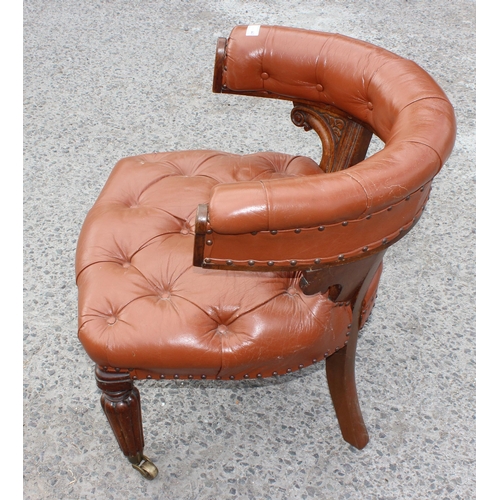 11 - An antique brown leather and oak library or desk chair with Chesterfield studded upholstery, likely ... 