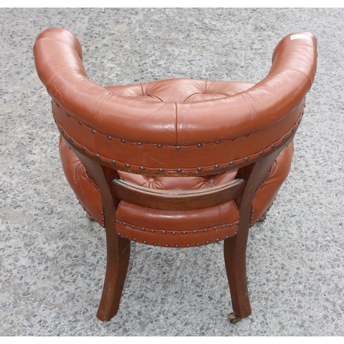 11 - An antique brown leather and oak library or desk chair with Chesterfield studded upholstery, likely ... 