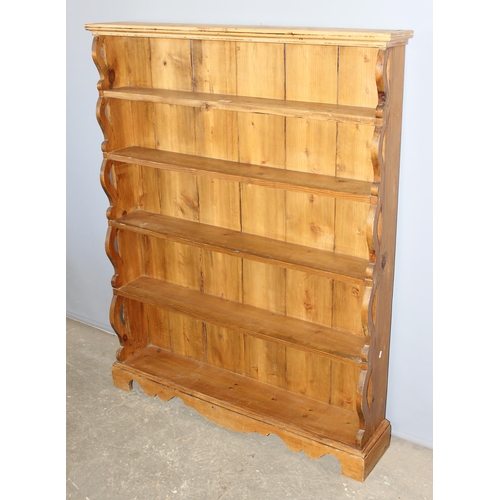 5 - A vintage pine waterfall bookcase with pierced ends, approx 109cm wide x 138cm tall x 25cm deep