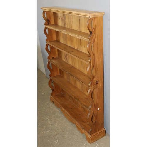 5 - A vintage pine waterfall bookcase with pierced ends, approx 109cm wide x 138cm tall x 25cm deep