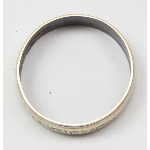 1115 - A 9ct gold wedding band ring with engraved decoration, Birmingham 1947, approx size N, approx 1.88g ... 