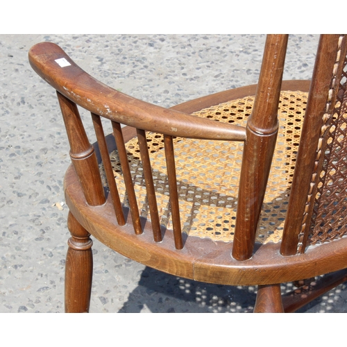 101 - A pair of early 20th century bergere seated armchairs