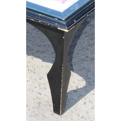 105 - David Moren Brown, local cabinet maker, a black painted and glass topped bijouterie table, retailed ... 