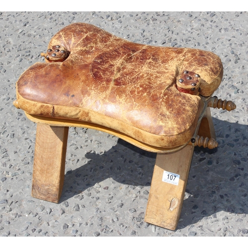 107 - A vintage leather and wooden camel stool, approx 53cm wide x 32cm tall x 33cm deep