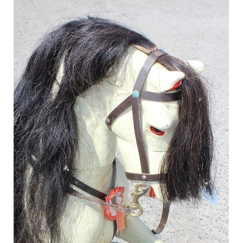 110 - A vintage painted carved wooden rocking horse on wooden frame, approx 108cm long