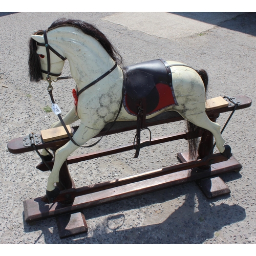 110 - A vintage painted carved wooden rocking horse on wooden frame, approx 108cm long