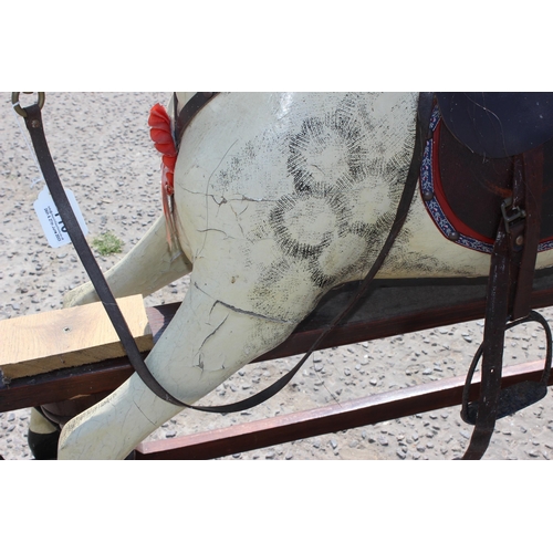 110 - A vintage painted carved wooden rocking horse on wooden frame, approx 108cm long