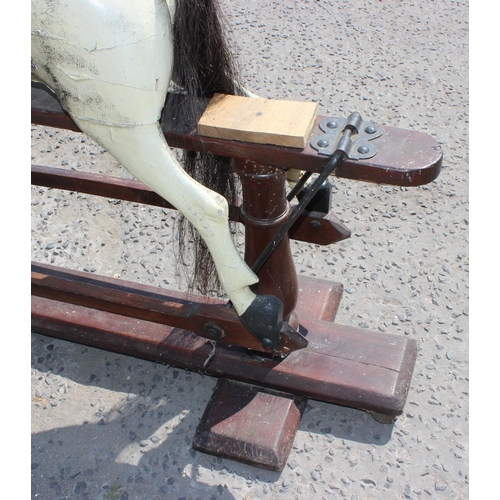 110 - A vintage painted carved wooden rocking horse on wooden frame, approx 108cm long