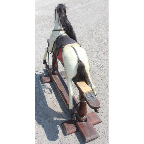 110 - A vintage painted carved wooden rocking horse on wooden frame, approx 108cm long