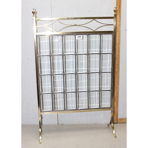 177 - An early 20th century polished brass fire screen with leaded bevelled glass panels