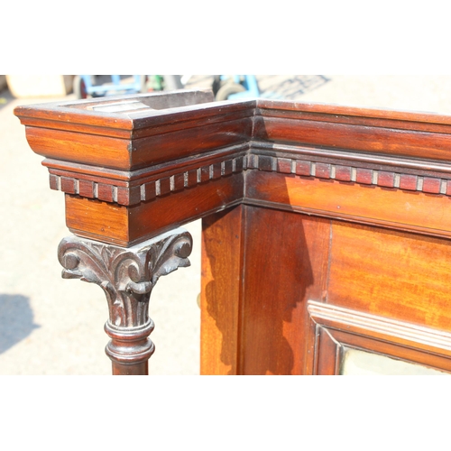 97 - An antique mahogany framed overmantel mirror with carved pillars, approx 140cm wide x 100cm tall