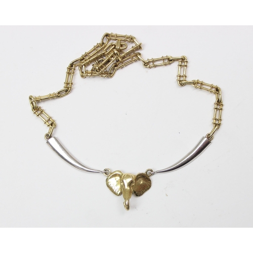 1119 - A heavy 9ct gold and white gold necklace set with an elephants head, marked 9k and 375 in various pl... 