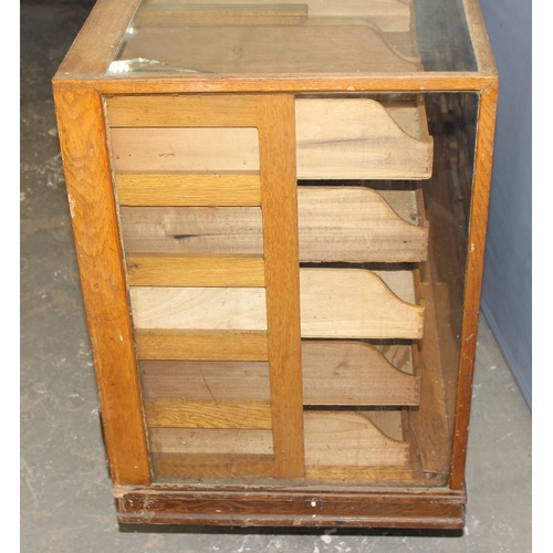 81 - An early 20th century light oak haberdashery shop counter or display cabinet with 30 drawers with br... 