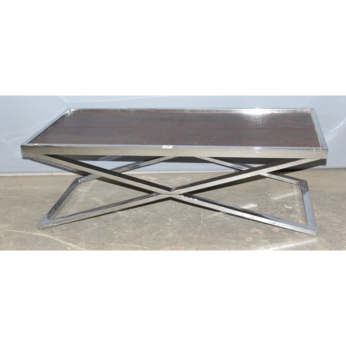 74 - An Andrew Martin style chrome and leather topped coffee table on X shaped base, approx 120cm wide x ... 