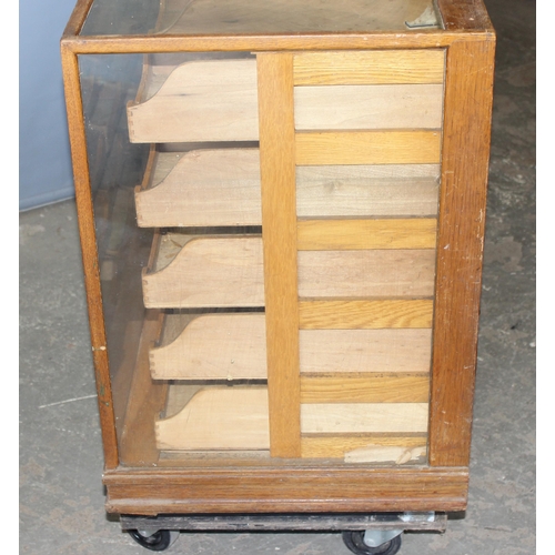 81 - An early 20th century light oak haberdashery shop counter or display cabinet with 30 drawers with br... 