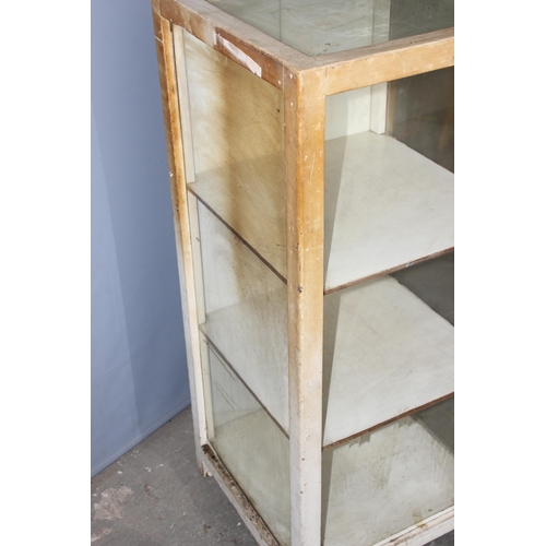 83 - A vintage white painted glazed shop display cabinet with 3 glazed sides and 2 rear doors, approx 53c... 