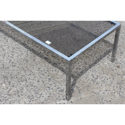 55 - A retro chrome and smoked glass coffee table, approx 122cm wide x 61cm deep x 39cm tall