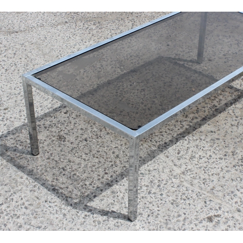 55 - A retro chrome and smoked glass coffee table, approx 122cm wide x 61cm deep x 39cm tall