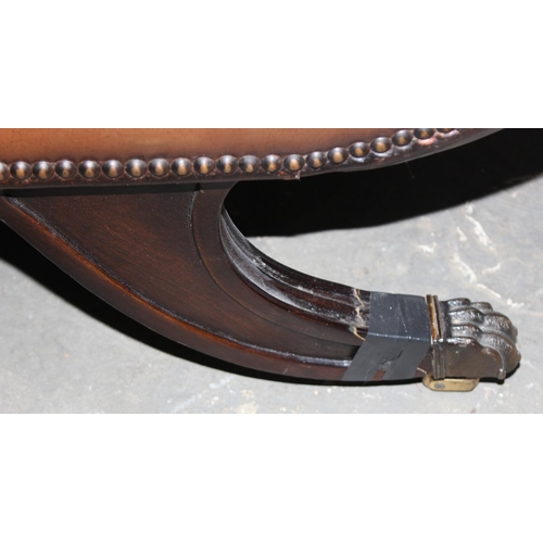 9 - A Regency style scroll arm window seat with brown leather upholstery and studded decoration, bearing... 