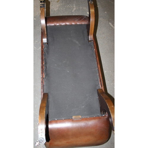 9 - A Regency style scroll arm window seat with brown leather upholstery and studded decoration, bearing... 
