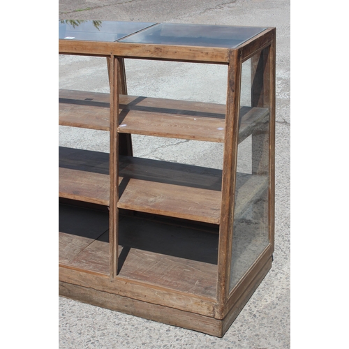 87 - A vintage shop display cabinet or counter of slanted form, approx 150cm wide x 110cm tall