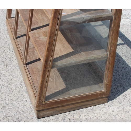 87 - A vintage shop display cabinet or counter of slanted form, approx 150cm wide x 110cm tall