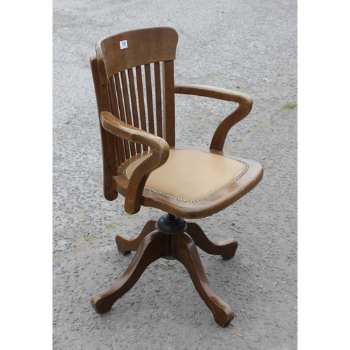 5 - An early 20th century oak slat back office chair