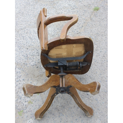 5 - An early 20th century oak slat back office chair