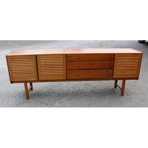 55A - A retro A.H. McIntosh of Kirkcaldy teak sideboard, with three central short drawers, the top drawer ... 