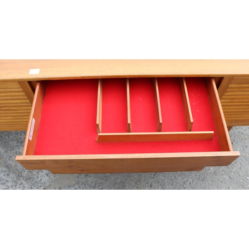 55A - A retro A.H. McIntosh of Kirkcaldy teak sideboard, with three central short drawers, the top drawer ... 