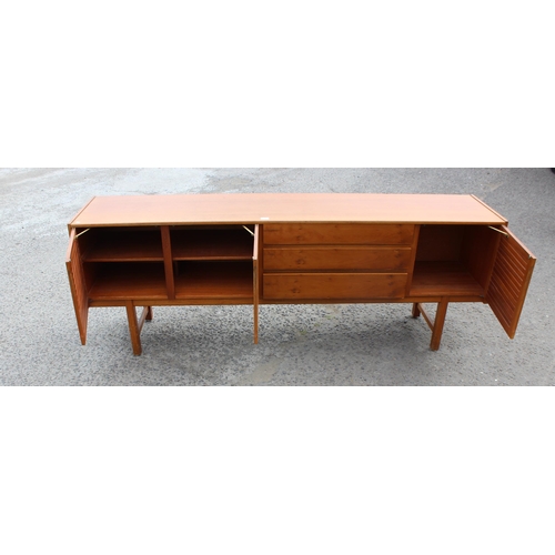 55A - A retro A.H. McIntosh of Kirkcaldy teak sideboard, with three central short drawers, the top drawer ... 