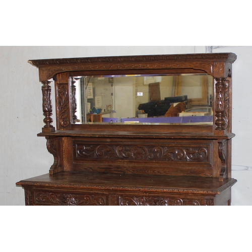 50 - An antique 17th century style carved oak sideboard or chiffonier with mirror back and lion mask hand... 