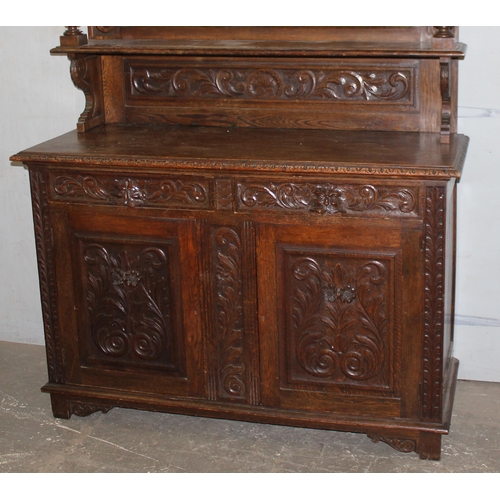 50 - An antique 17th century style carved oak sideboard or chiffonier with mirror back and lion mask hand... 