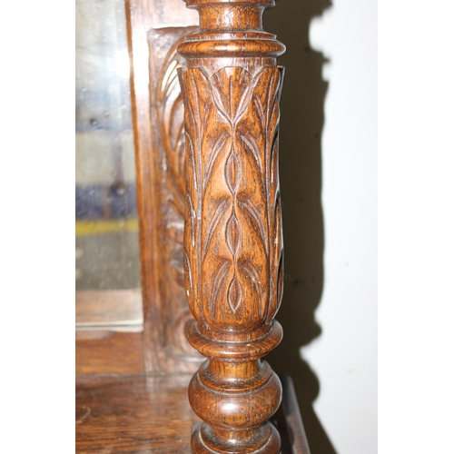 50 - An antique 17th century style carved oak sideboard or chiffonier with mirror back and lion mask hand... 