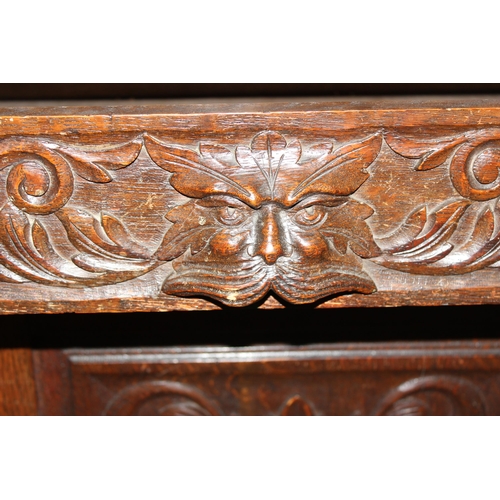 50 - An antique 17th century style carved oak sideboard or chiffonier with mirror back and lion mask hand... 