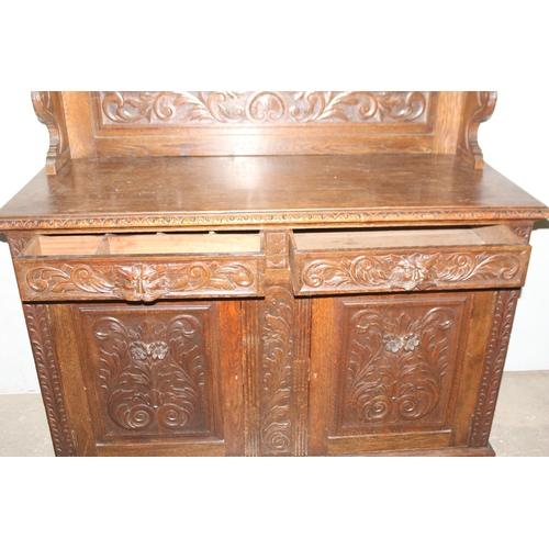 50 - An antique 17th century style carved oak sideboard or chiffonier with mirror back and lion mask hand... 